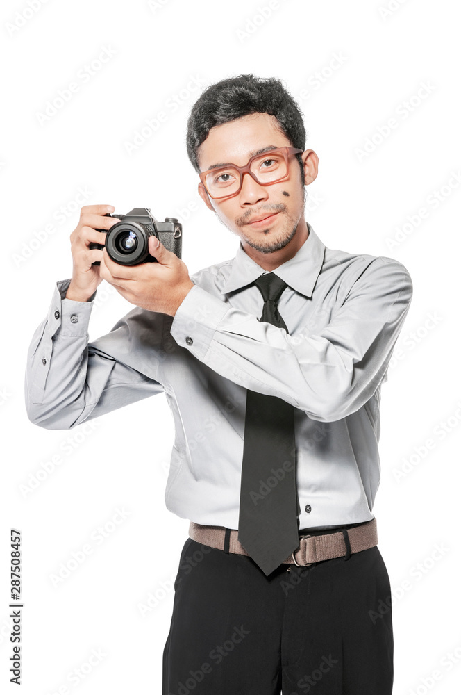 Asian businessman holding the camera on his hand standing Asian businessman holding the camera on his hand standing