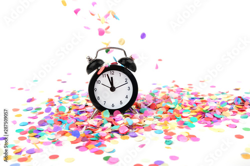 alarm clock and colorful confetti. Top view flatlay alarm clock and bright confetti. concept party, festive decor. Minimalism styled holiday time concept. copy space