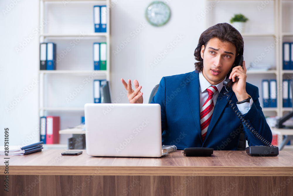 Young male businessman working in the office Young male businessman working in the office
