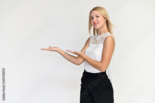 Portrait of a pretty blonde girl in a white blouse on a white background. Beauty, brightness, happiness. Shows different emotions in different poses.