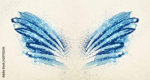 Blue glitter on abstract blue watercolor wings in vintage nostalgic colors.