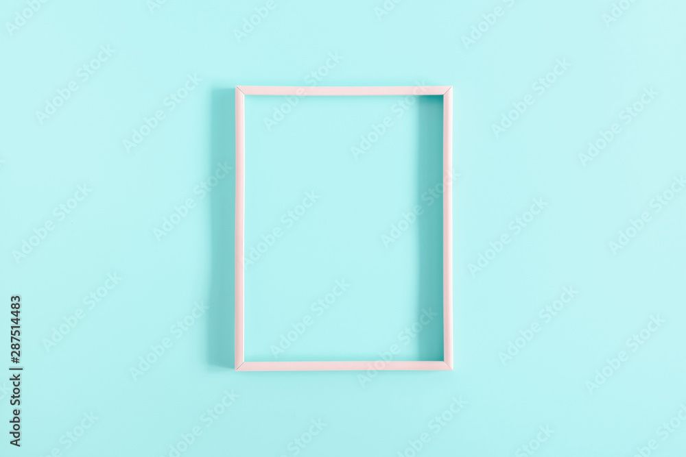 Empty pink photo frame on pastel blue background. Flat lay, top view, copy space Empty pink photo frame on pastel blue background. Flat lay, top view, copy space