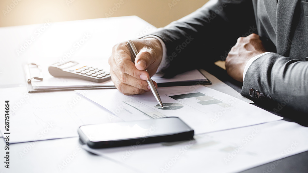 Business man working at office with laptop and documents on his desk Business man working at office with laptop and documents on his desk