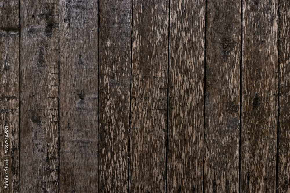 The texture of an old unpainted wall of wooden boards . Lots of knots in the boards The texture of an old unpainted wall of wooden boards . Lots of knots in the boards