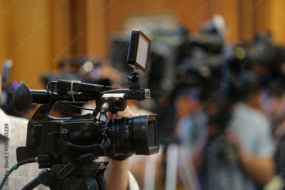 Details with television video cameras and recording equipment during a press event