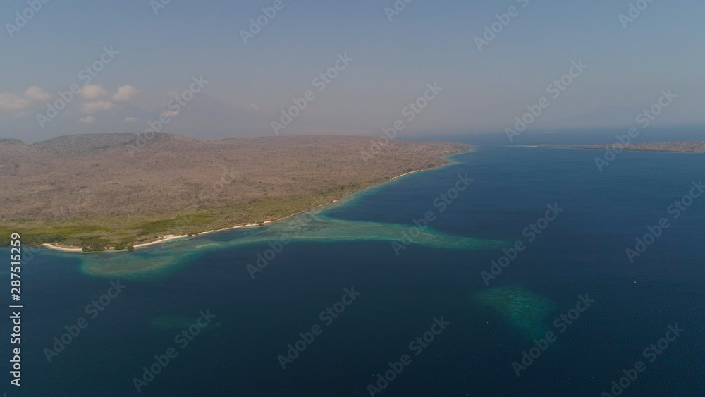 aerial view coastline with beach and coral reef coral reef. seascape atoll with bay turquoise water in sea.Tropical coral reef in ocean waters. Travel concept.