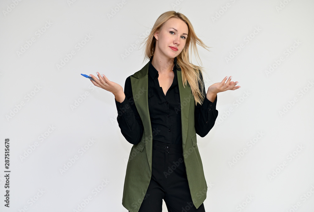 Portrait of a pretty blonde girl in a dark suit on a white background. Beauty, brightness, happiness, business look. Shows different emotions in different poses. Portrait of a pretty blonde girl in a dark suit on a white background. Beauty, brightness, happiness, business look. Shows different emotions in different poses.