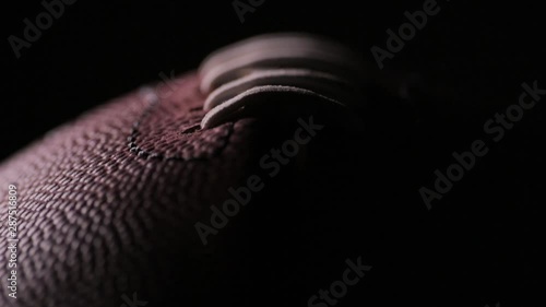 Darkened close up of American Football laces C