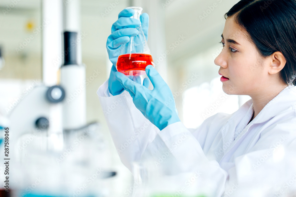 Positive delighted female scientist doing experiment