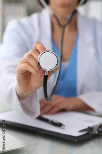 Doctor with a stethoscope in the hands, close up. Physician ready to examine and help patient. Medicine, healthcare and help concept