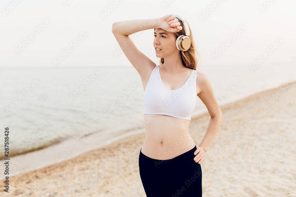 Young sports girl goes in for sports in the open air, on the sea Young sports girl goes in for sports in the open air, on the sea