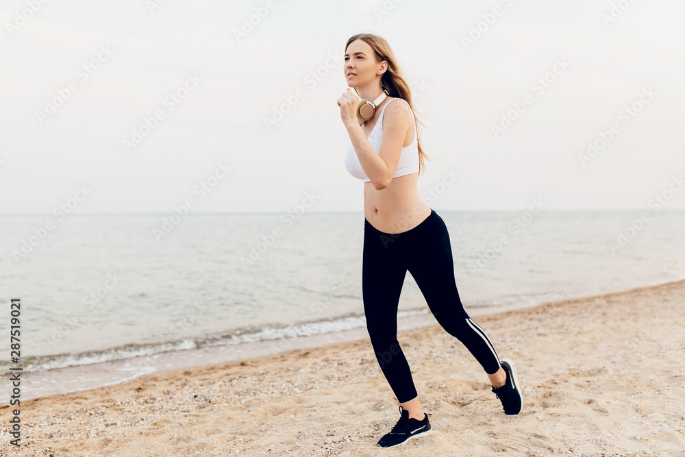 Sporty beautiful girl, on a morning jog, outdoors in the sea. Athletics Sporty beautiful girl, on a morning jog, outdoors in the sea. Athletics