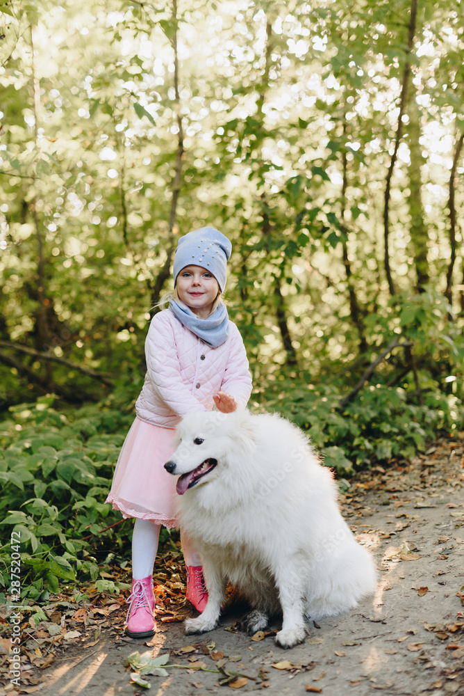 little girl with a big white dog in nature little girl with a big white dog in nature