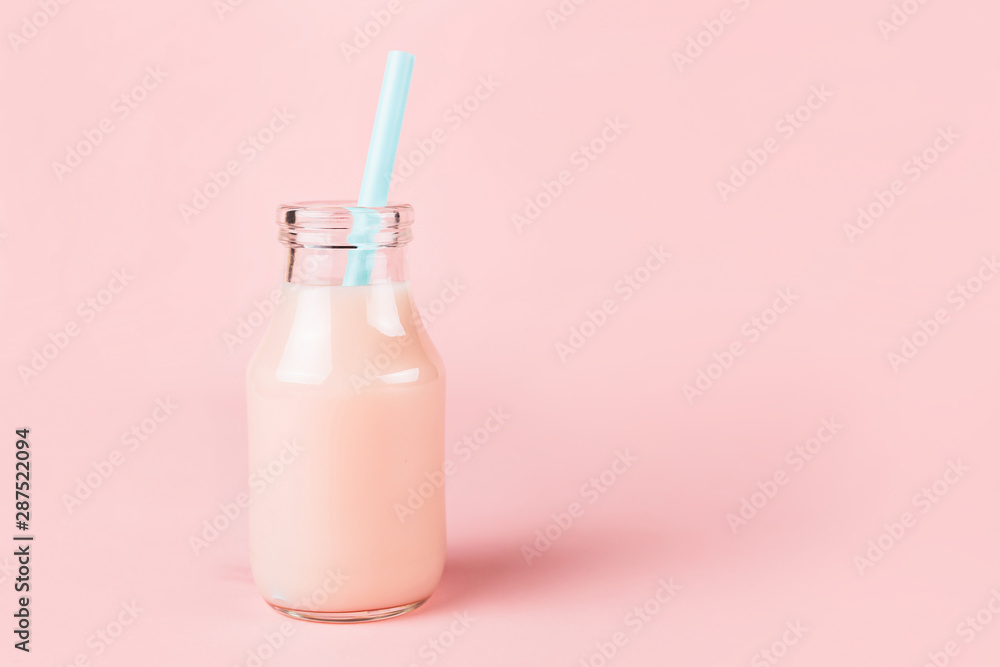 A bottle of drink on pink background. A bottle of drink on pink background.