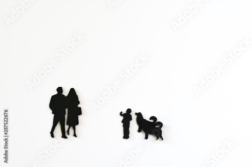 Miniature people  flat in black   father  mother son and dog on white background with copy space. In concept family.