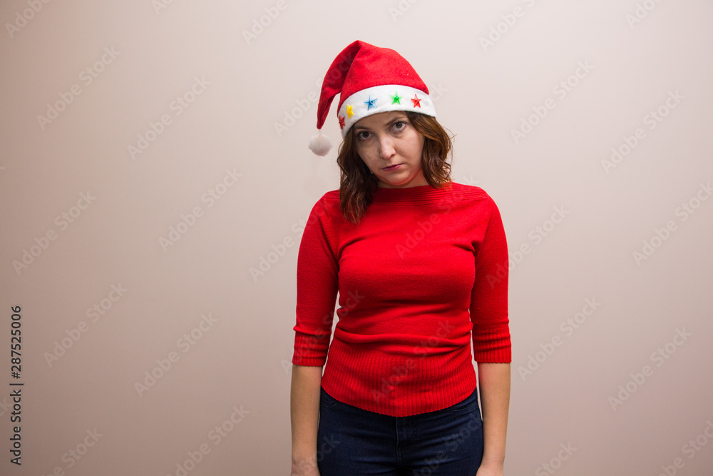 happy girl in santa hat in red blouse on white background happy girl in santa hat in red blouse on white background