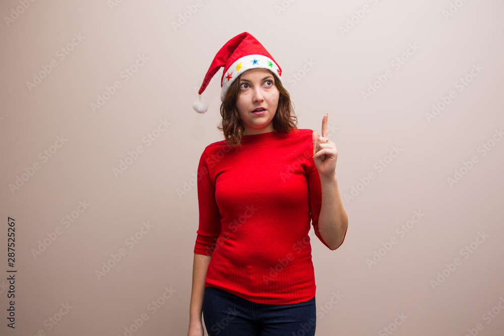happy girl in santa hat in red blouse on white background happy girl in santa hat in red blouse on white background