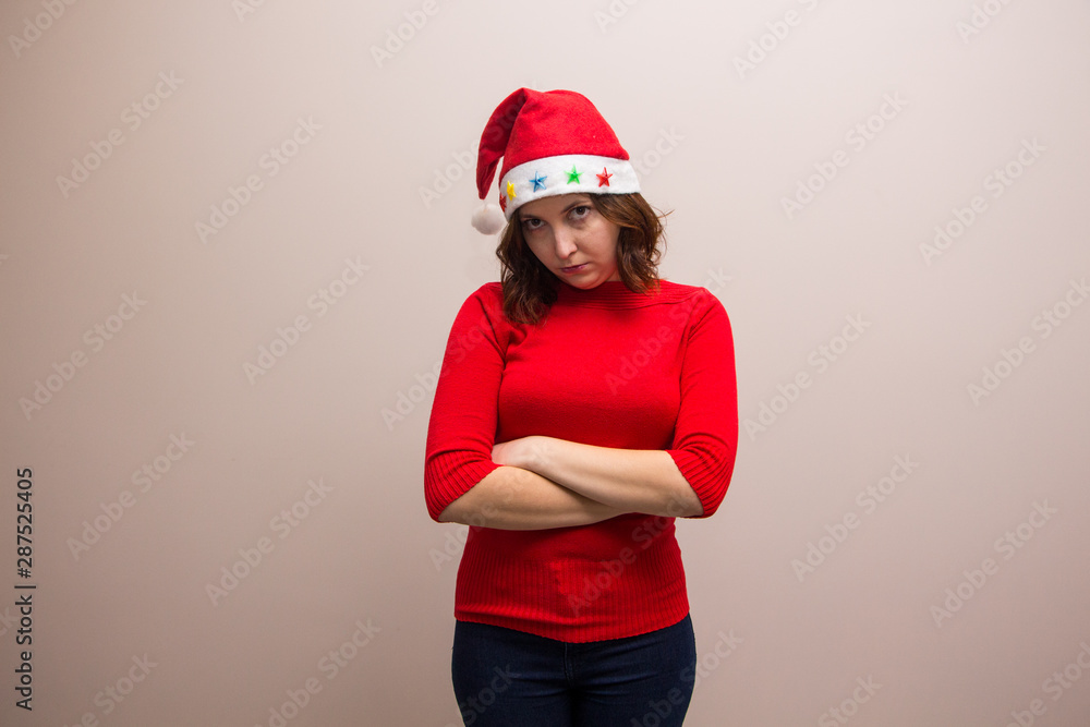 happy girl in santa hat in red blouse on white background 