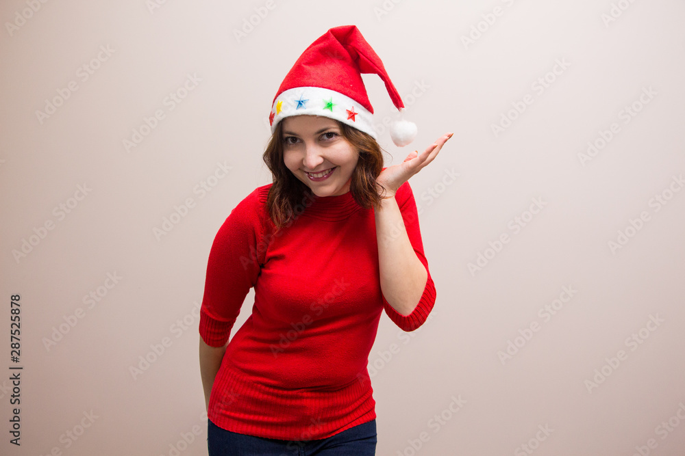 happy girl in santa hat in red blouse on white background happy girl in santa hat in red blouse on white background