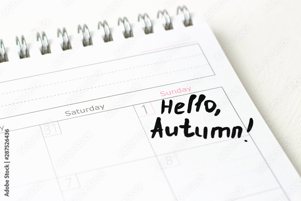 The inscription Hello, autumn on a white calendar, close-up The inscription Hello, autumn on a white calendar, close-up