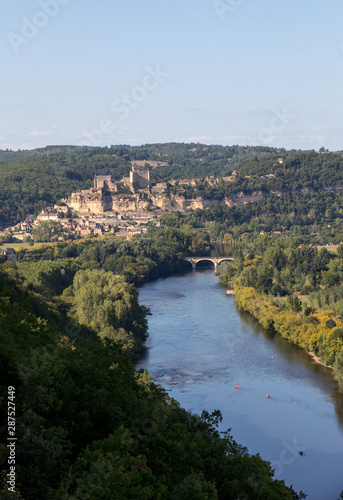  The medieval Chateau de Beynac rising on a limestone cliff above the Dordogne River seen from Castelnaud. France, Dordogne department, Beynac-et-Cazenac