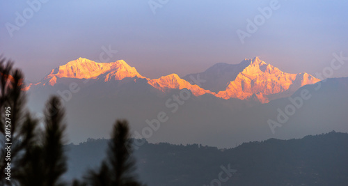 A view of Snow clad Kangchenjunga, also spelled Kanchenjunga, is the third highest mountain in the world. It lies between Nepal and Sikkim, India,   photo