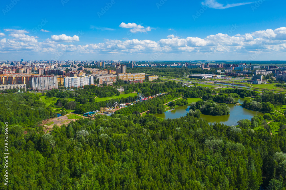 Aerial view of South Seaside Park on southwest part of St. Petersburg city. Summer, a lot of green trees, blue sky. Russia country