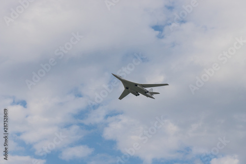 Military bomber aircraft flying in the cloudy sky