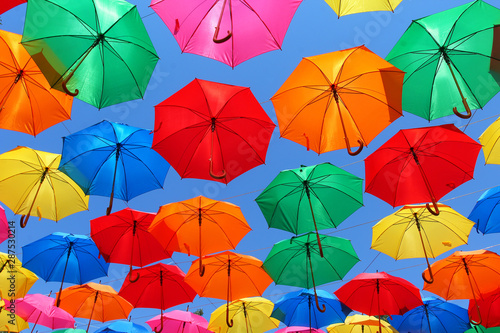 colored umbrellas on a background of blue sky