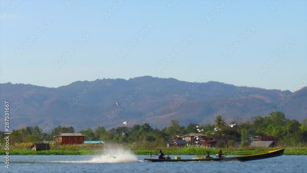Inle lake Shan State Myanmar.Floating Gardens and Villages. Commerce and Trade primarily by Long Boats. Surreal vision with mountainous backdrops. Inle lake Shan State Myanmar.Floating Gardens and Villages. Commerce and Trade primarily by Long Boats. Surreal vision with mountainous backdrops.