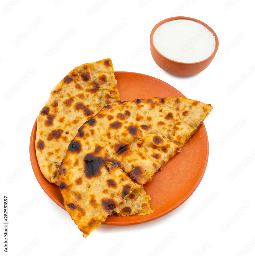 Indian Traditional Breakfast Dish Aloo Paratha is a Potato Stuffed Flatbread Served With Fresh Curd on White Background Indian Traditional Breakfast Dish Aloo Paratha is a Potato Stuffed Flatbread Served With Fresh Curd on White Background