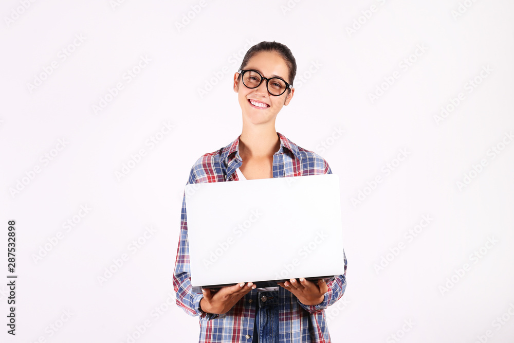 Young beautiful brunette woman with long black straight hair posing over bright colorful isolated background & holding laptop. Portrait of teenage female model showing emotions. Close up, copy space. Young beautiful brunette woman with long black straight hair posing over bright colorful isolated background & holding laptop. Portrait of teenage female model showing emotions. Close up, copy space.