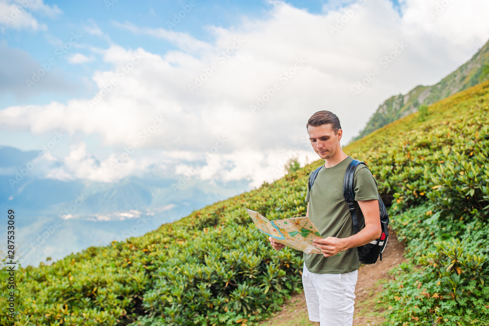 Fototapeta premium Tourist man in mountains in the background of fog