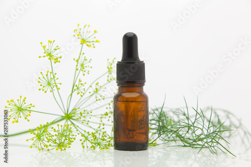 Fototapeta Naklejka Na Ścianę i Meble -  dill essential oil in  beautiful bottle on White background