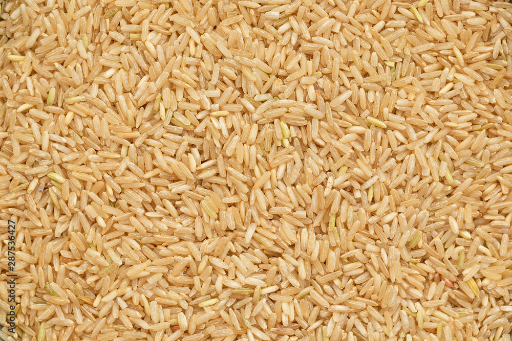 Grain brown rice background. Brown rice is whole grain. Food background. Top view Grain brown rice background. Brown rice is whole grain. Food background. Top view