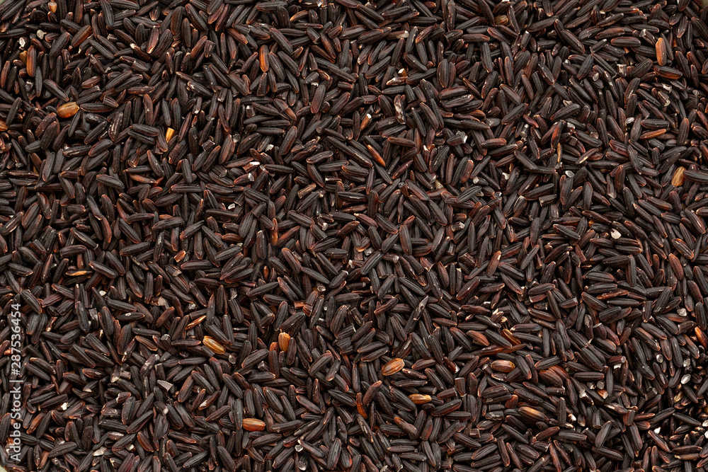 Grain black rice background. Black rice is whole grain. Food background. Top view Grain black rice background. Black rice is whole grain. Food background. Top view