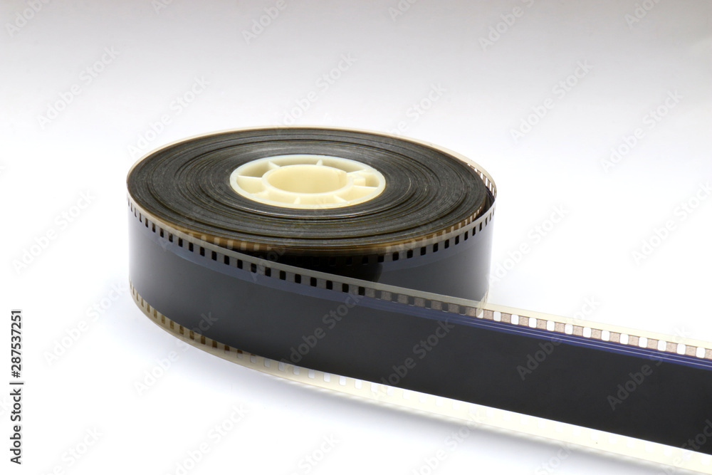 35mm Movie Trailer Film Roll on a Bobby. This is a 2-3 minute long film strip. You can see the perforations with the digital soundtrack inbetween and the analog soundtrack next to it