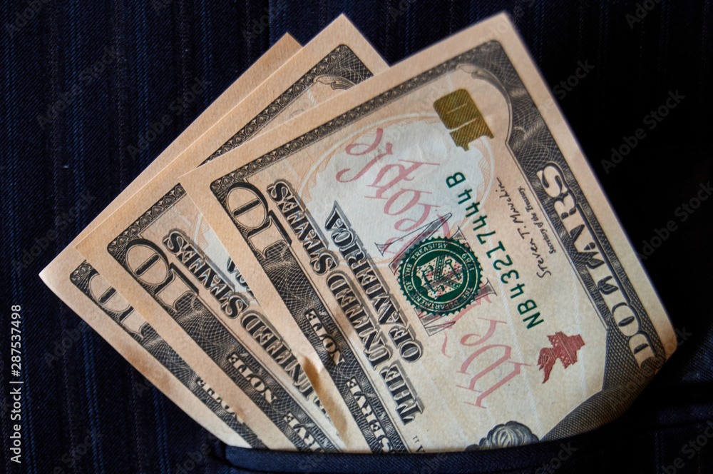 Money in the pocket. A photo of dollars in the dark blue jacket Money in the pocket. A photo of dollars in the dark blue jacket
