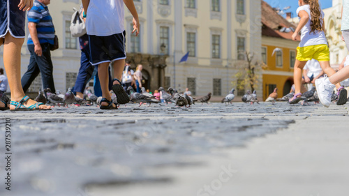 Summer in the city, old cobbled street. View at the sidewalk.