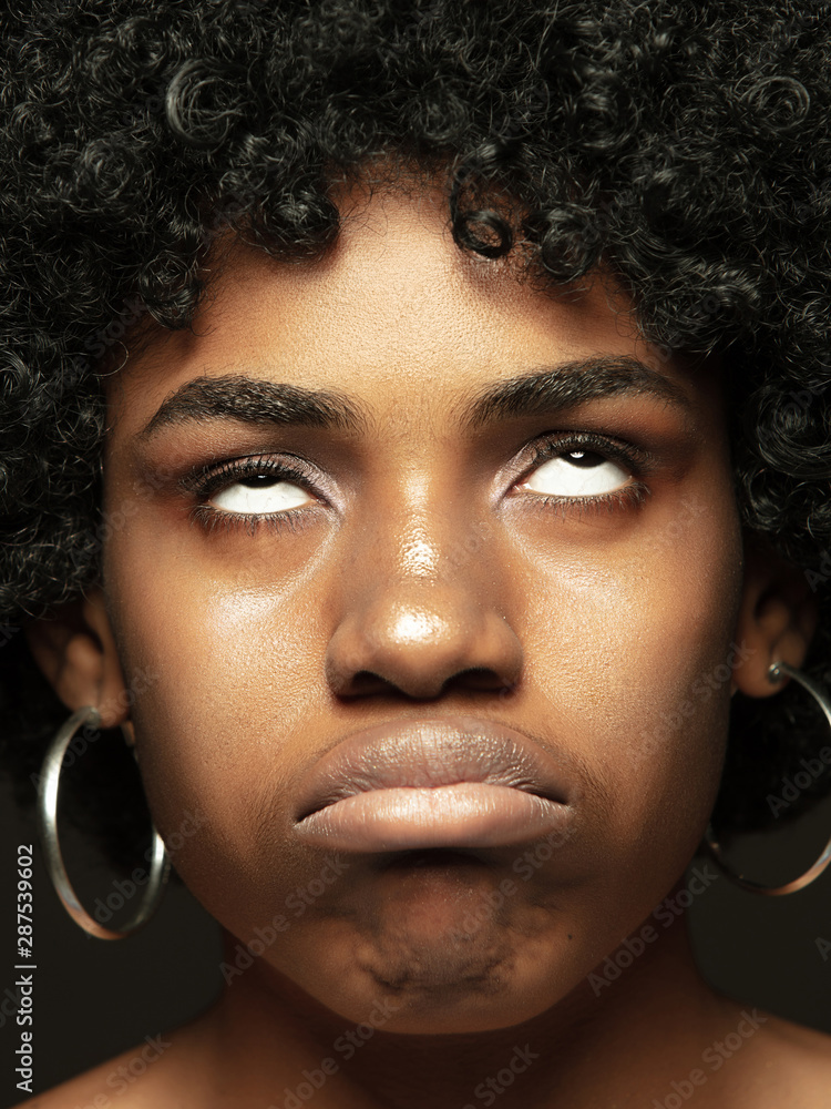 Close up portrait of young, emotional african-american woman. Highly detail photoshot of female model with well-kept skin and bright facial expression. Concept of human emotions. Gremaces. Close up portrait of young, emotional african-american woman. Highly detail photoshot of female model with well-kept skin and bright facial expression. Concept of human emotions. Gremaces.