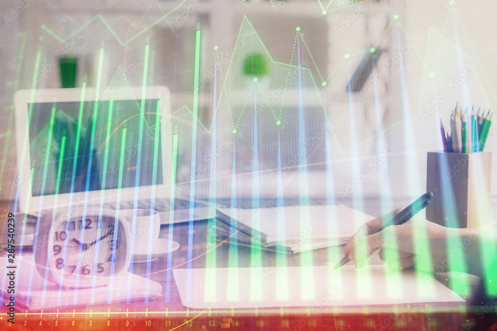 Financial graph displayed on woman's hand taking notes background. Concept of research. Multi exposure Financial graph displayed on woman's hand taking notes background. Concept of research. Multi exposure