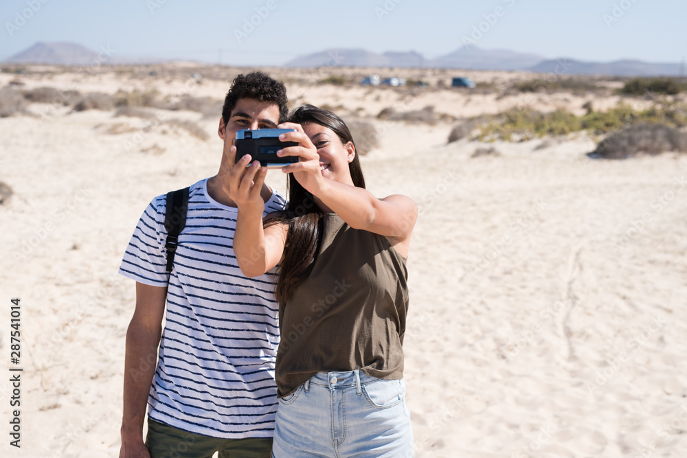 Couple take a photo of themselves at the beach