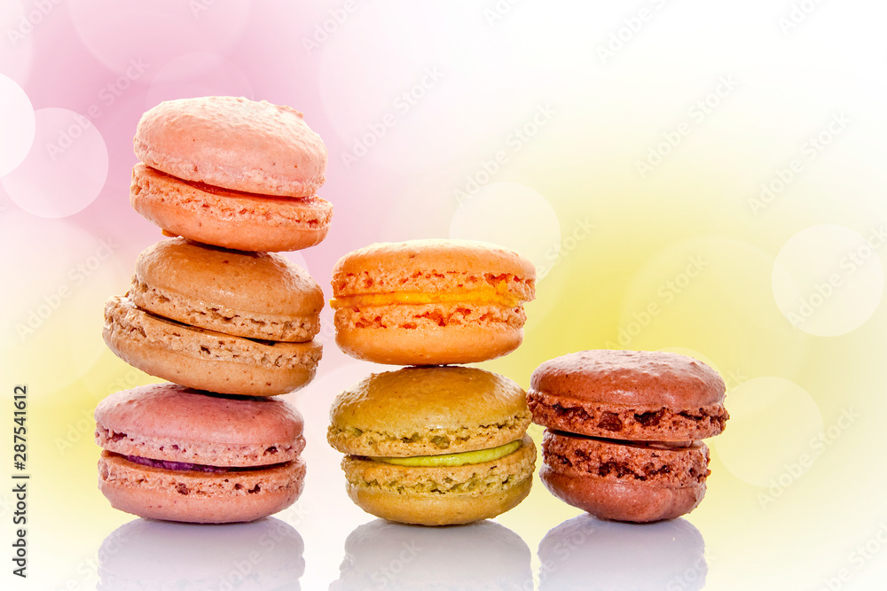Stack of pastel colored french macarons, bokeh background