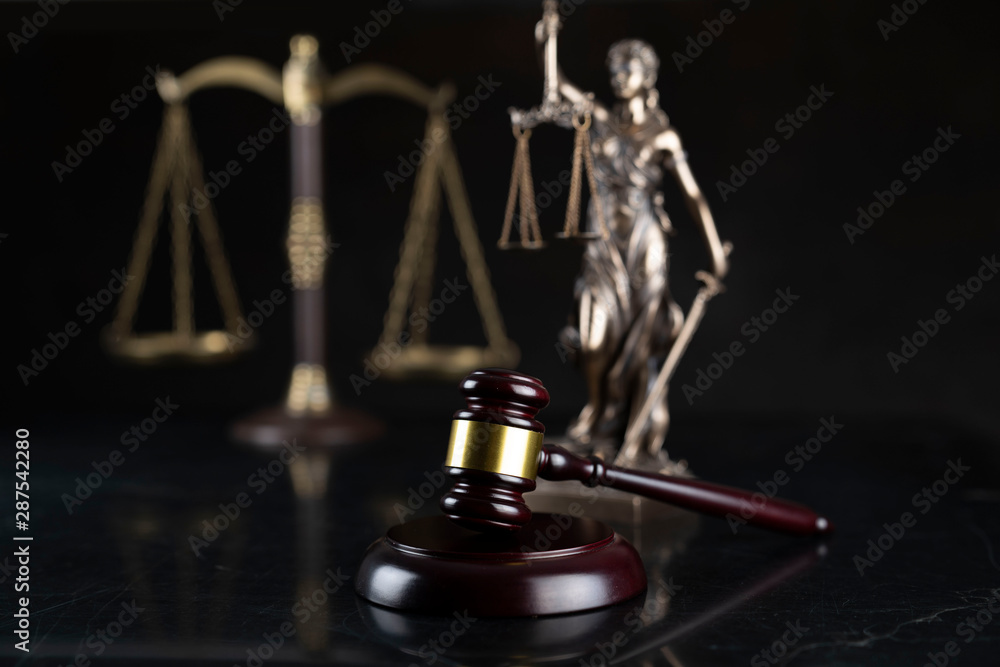 Law and justice theme. Gavel of the judge, Themis statue and the scale on the dark background. Law and justice theme. Gavel of the judge, Themis statue and the scale on the dark background.