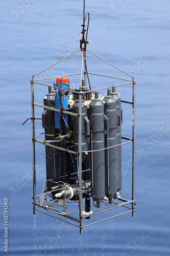 CTD rosette sampler with bathometers and other science equipment for measurement of underwater environment parameters like temperature, salinity and others.