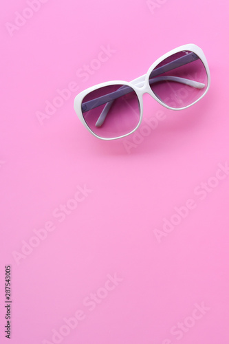 Modern fashionable sunglasses on pink background