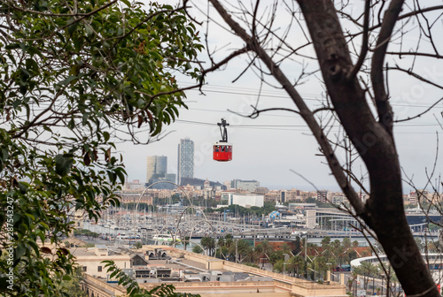 Iconic Barcelona's red aerial tramway moving over Port Vell. The red Funicular. photo