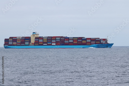 Container cargo ship underway in the ocean.