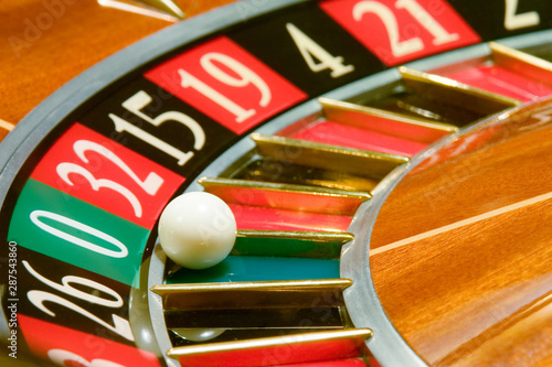 Canvas Print Roulette table in casino, with many games and slots, roulette wheel in the foreground