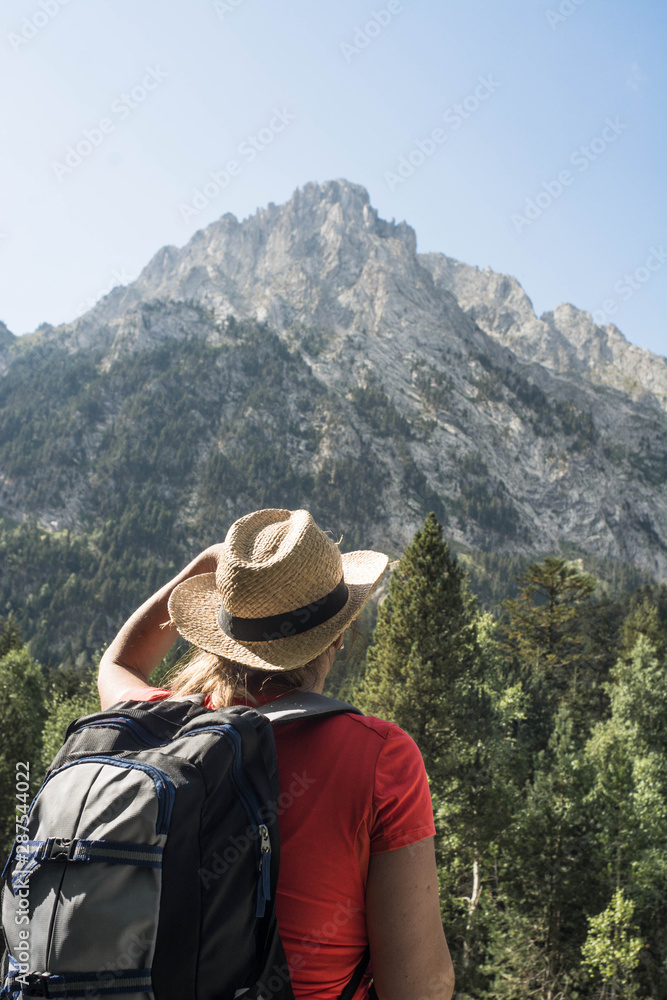 woman hiking in the national park d´aiguestortes in the Pyrenees in Spain